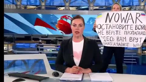 Woman rushed in front of the camera during a news live broadcast on Russia's main TV channel with a poster reading "Stop the war! Don’t believe propaganda! They’re lying to you here!"