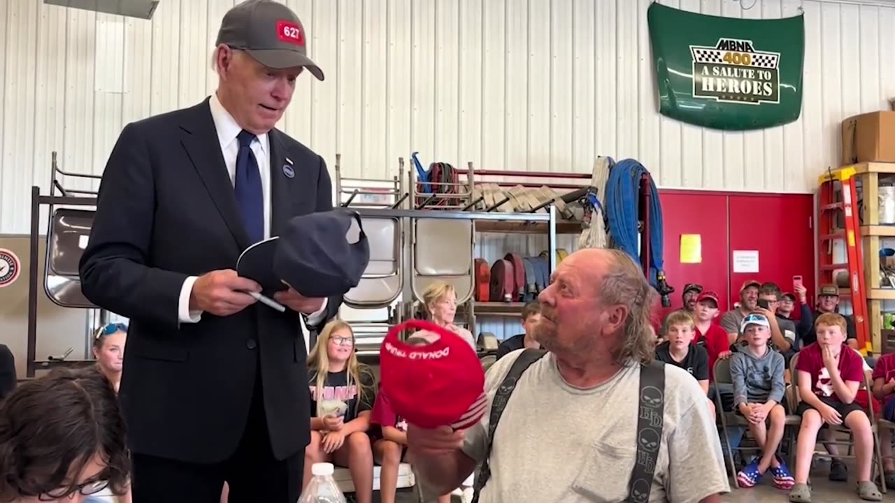 Biden’s Trump hat gesture win cheers from crowd