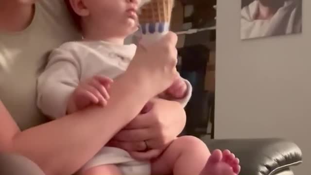 This baby's first taste of ice cream is so cool