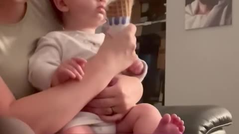 This baby's first taste of ice cream is so cool