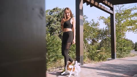 Young adult girl spending weekend day together with little dog