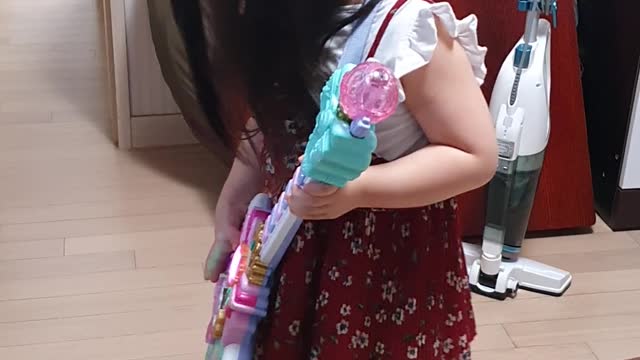 a toy-guitar-playing