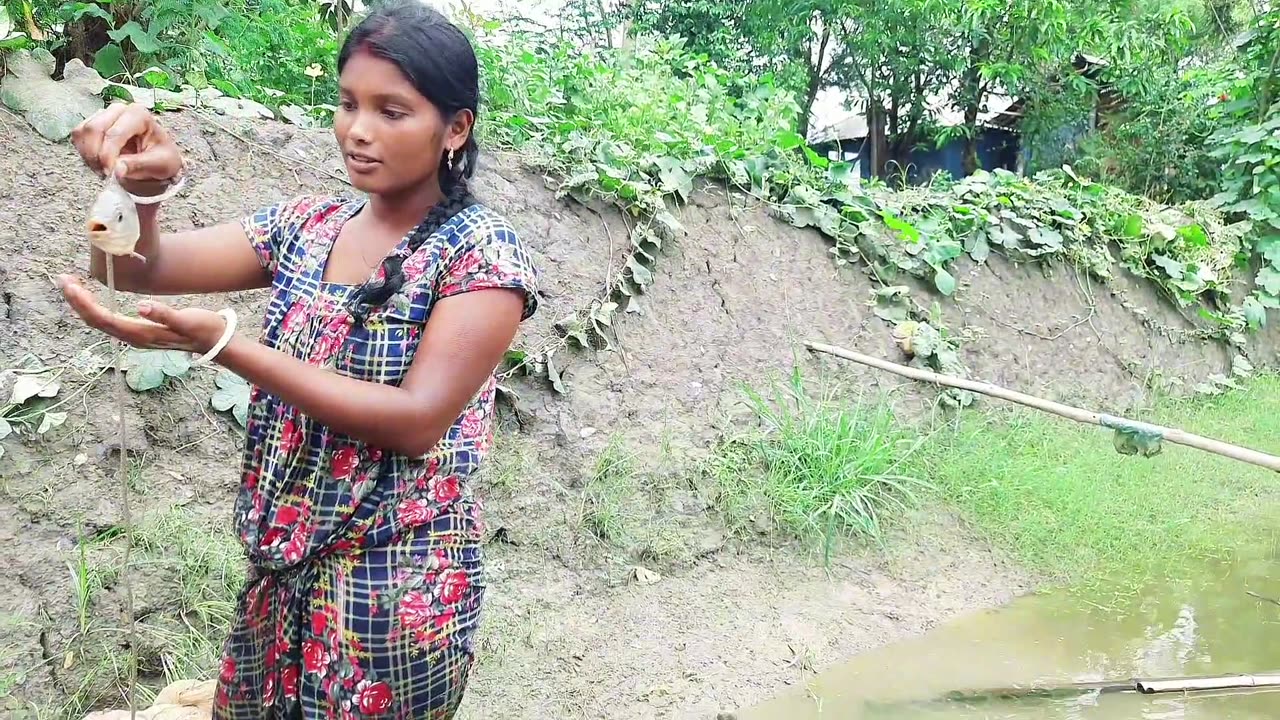 Village Amazing Woman Catching Fish In The Lily Pond.