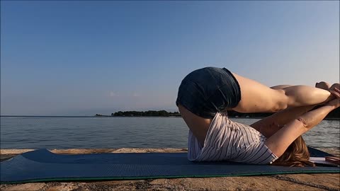 A Woman Exercising By The Seaside