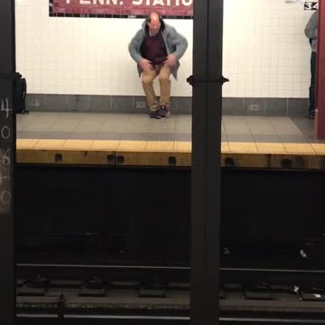 Bald guy blue jacket dances in subway