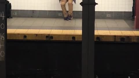 Bald guy blue jacket dances in subway