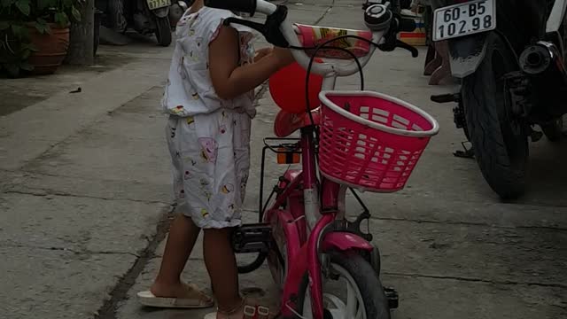 Cute baby trying to drive through little eel in the middle of the road.