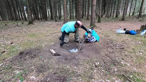 Clearing away the firewood ready to clear away the firepit for leave no trace .