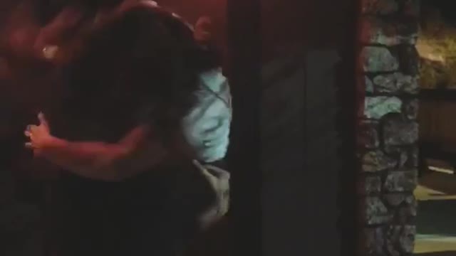 Girl jumping on guy and both falling