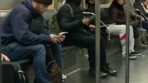 Man black jacket playing air drums on train