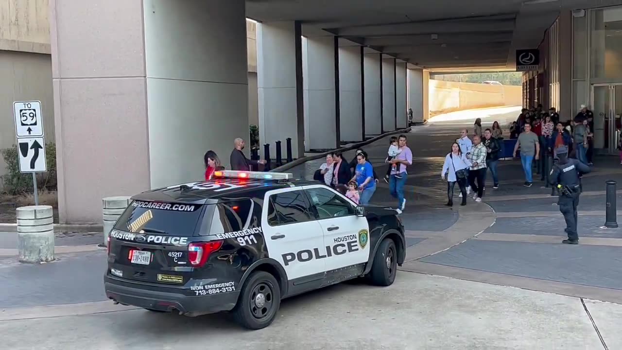 People being led out of Lakewood Church in Houston by officials after shooting