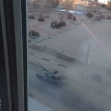 Ukrainian films tanks rolling past the window and tank fires shell