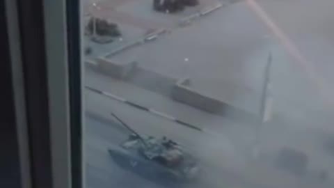 Ukrainian films tanks rolling past the window and tank fires shell