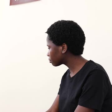 A Woman Looking up at a Sign on the Wall