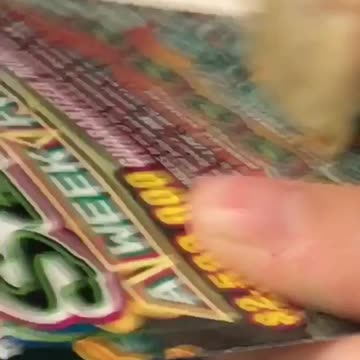 Woman scratches her lottery ticket with a piece of tortilla