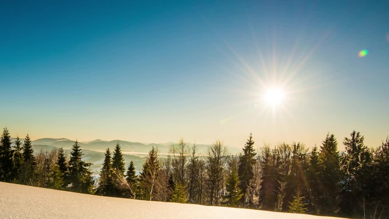 Bright sun in the clear sky in the snowy mountains