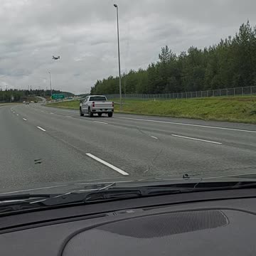 Two Military V-22 Ospreys flying by