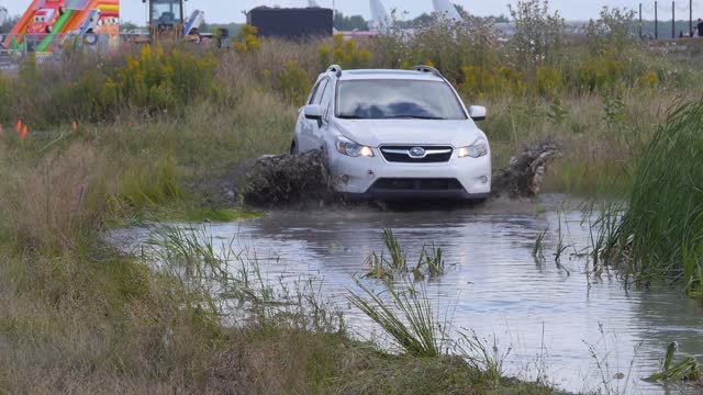 car racing in dirty water and slash