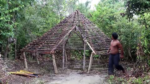 TALENTED MAN MAKING HOUSE IN THE FOREST