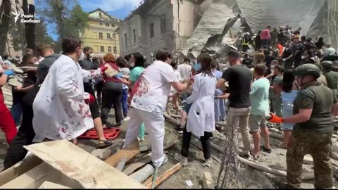 Doctors covered in blood and volunteers assisting ongoing rescue efforts at the Children's hospital