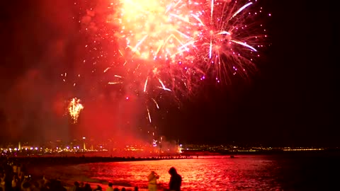 Fireworks illuminating the beach sky