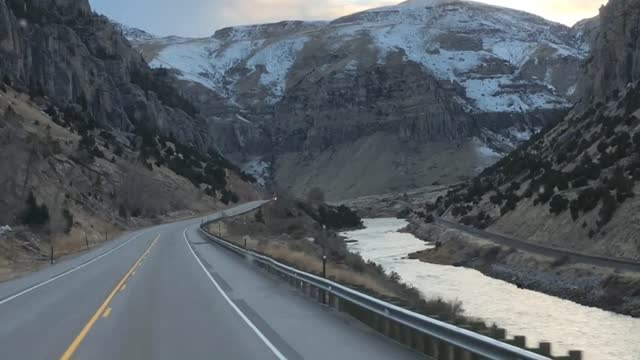 Travel Views - Driving Between Hills and River