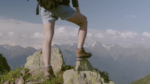 A Man Standing On The Mountain