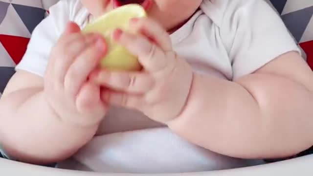 Baby tasting lemon for the first time