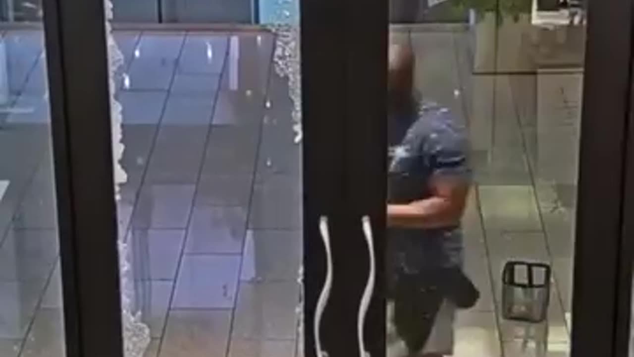 Video of suspected looter runs into glass door