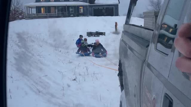 Sledding behind the truck