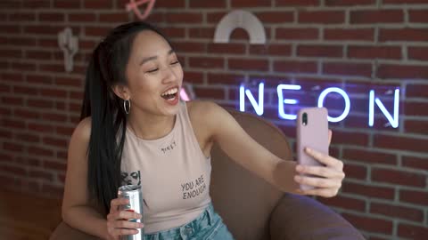 Taking her selfie after a bottle of beer