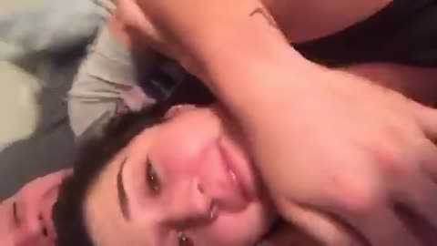 Girl black shirt in head lock sneezes out bugger