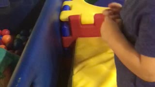 Little kid dives face first into ball pit