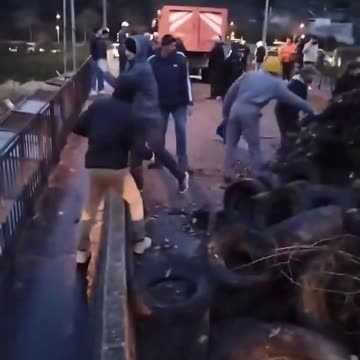 French farmers throw tires and refuse off a bridge onto high speed rail tracks