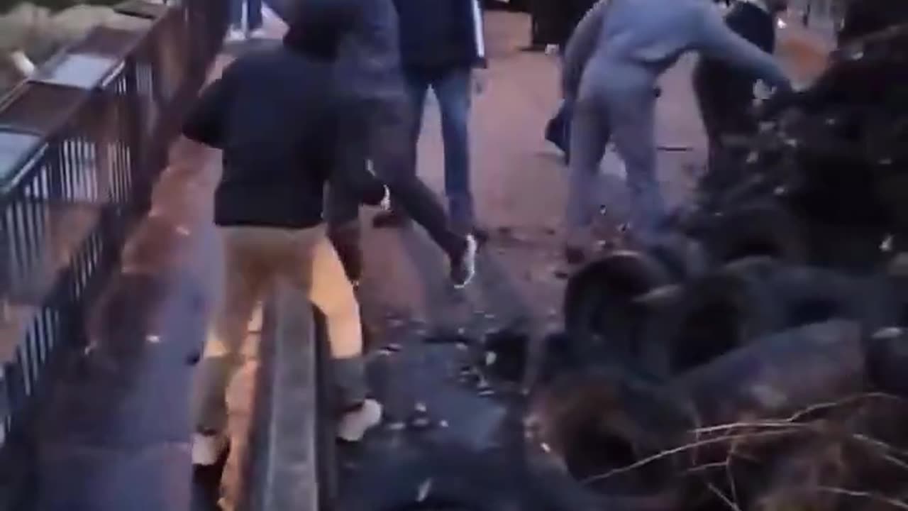 French farmers throw tires and refuse off a bridge onto high speed rail tracks