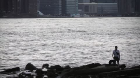 Man Walking Puppy near Water