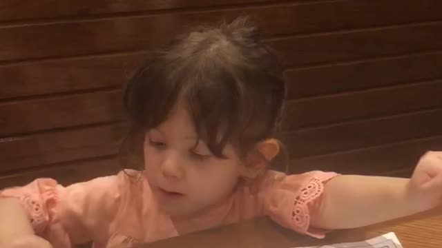 Sitting at a booth with her parents