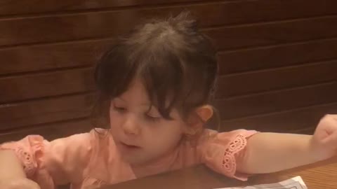 Sitting at a booth with her parents