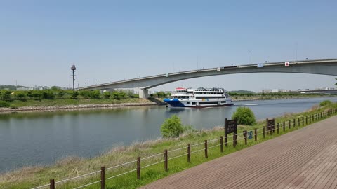 A cruise ship passing under the bridge.