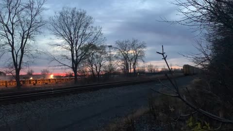 Double CSX engines with empty car carrier rail cars