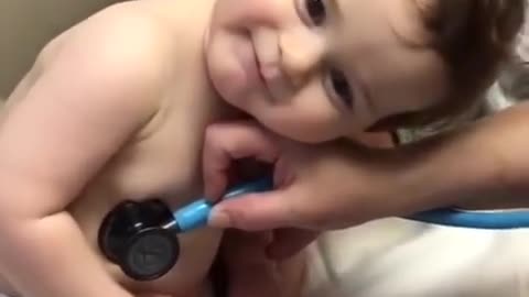 Sweet baby boy rests on nurse’s hand