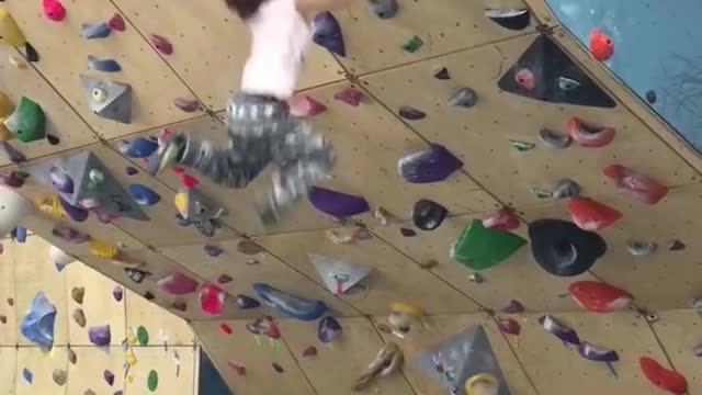 kid climbs Rock wall without Harness