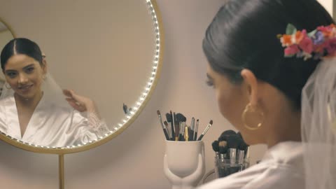 Woman preparing for her wedding in front of the mirror