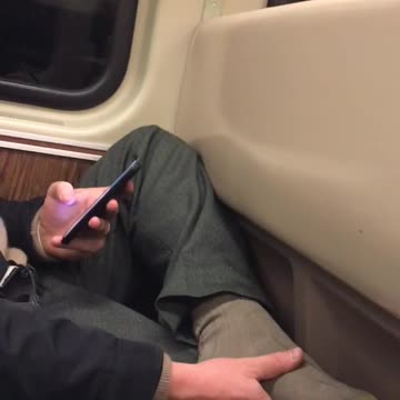 Man rubs his foot on subway train, smelly sock