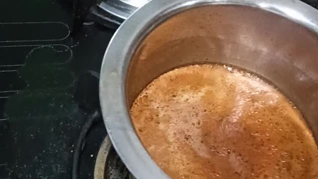 Pouring Indian Tea into a cup