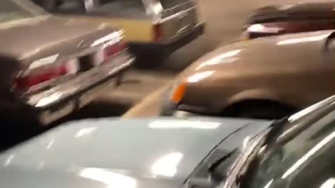 Guy Walks into Parking Garage Full of Retro Vehicles