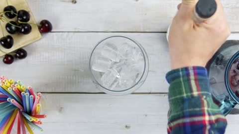 Top View Male Hands Pouring Ice and Spirit into a Glass