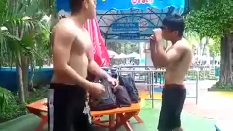 two young men practice martial arts together