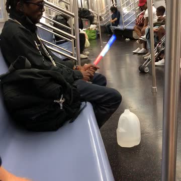 Man plays with red white and blue glow stick