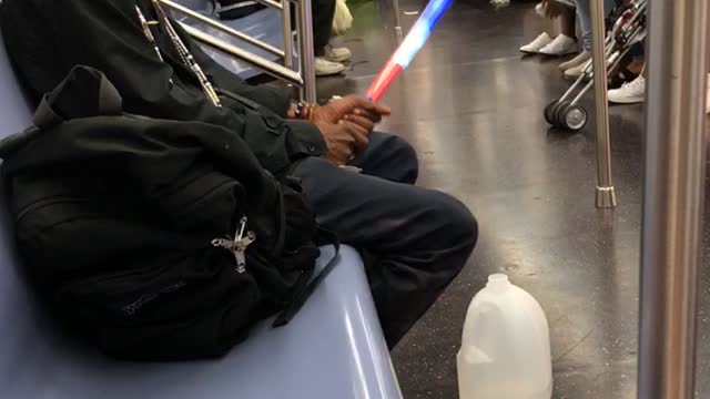 Man plays with red white and blue glow stick